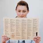 woman appreciating menu design against white backdrop