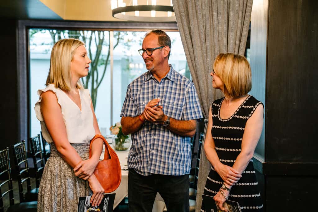 Meredith Marshall (left) talks with her nominator David Abes and her mom.