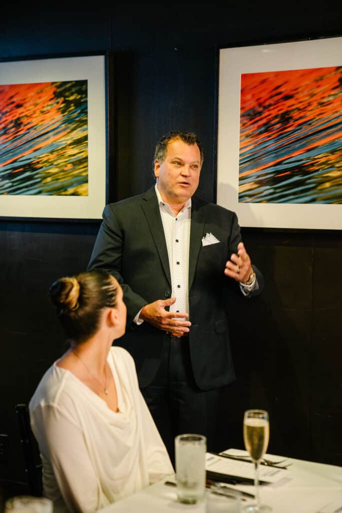 Tim Woods from Performance Foodservice stands up to give a speech.