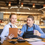 Woman and man in a restaurant going over paperwork