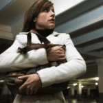 Woman clutching her purse in a dimly lit parking garage